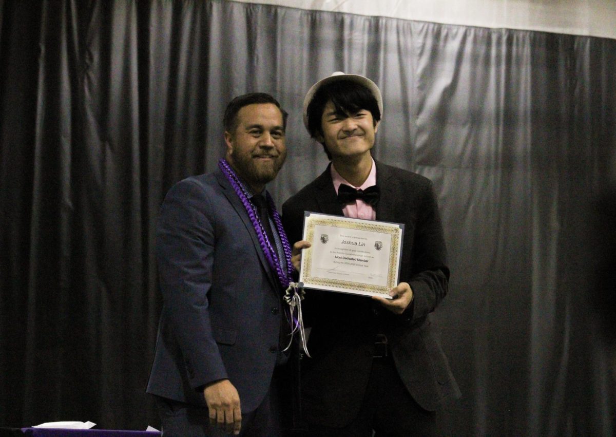 Senior, Joshua Lin, smiles for the camera with Mr. Ana after receiving the "Most Dedicated Member" award.