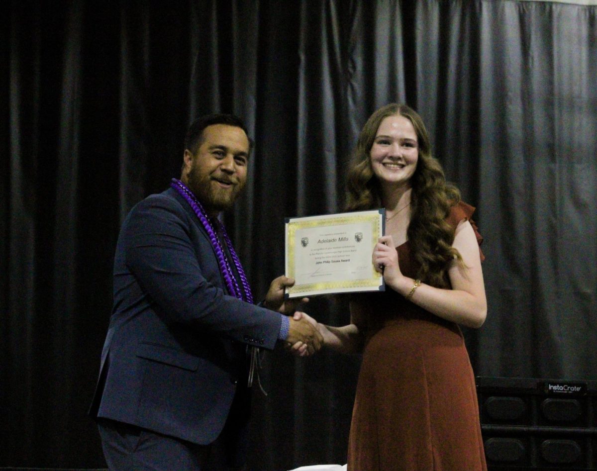 Senior, Adelaide Mills, is awarded the "John Philip Sousa" Award by band director Mr. James Ana.