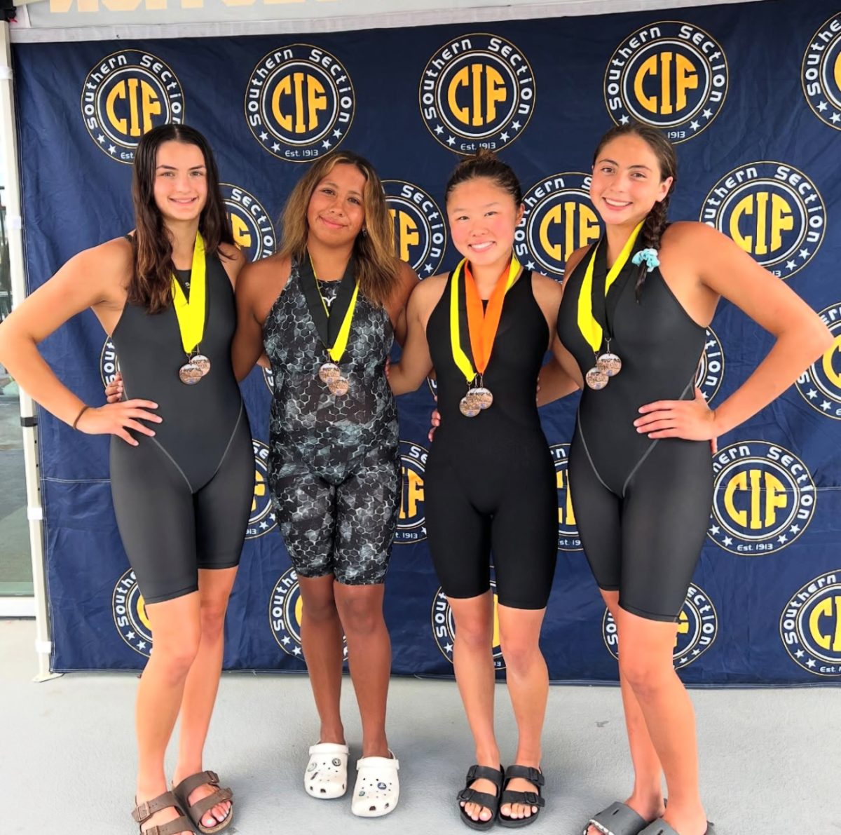 Sophomore Anastasya Gamboa, juniors Audrey Lee and Bella Fantocone, and Senior Megan Medina pose with their metals after they won their events in the CIF finals.