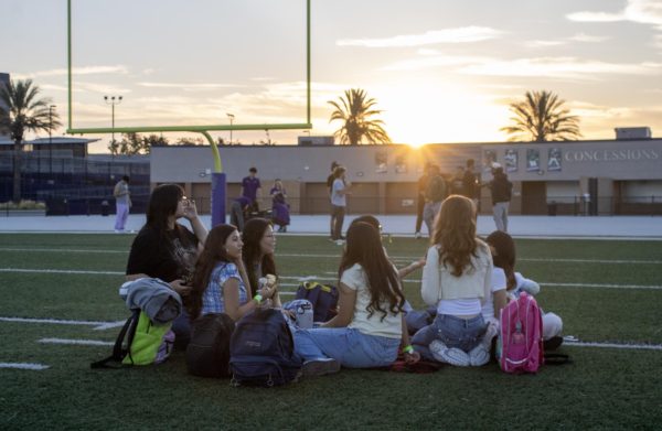 Groups of seniors gather with their friends on the Cougar Stadium's field to watch the sun begin to light up the sky at senior sunrise on Friday, Aug. 22.