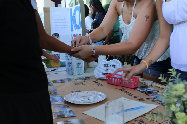 Sisters in Christ promotes their club by giving out fake tattoos at the 2025-2026 Club Rush.