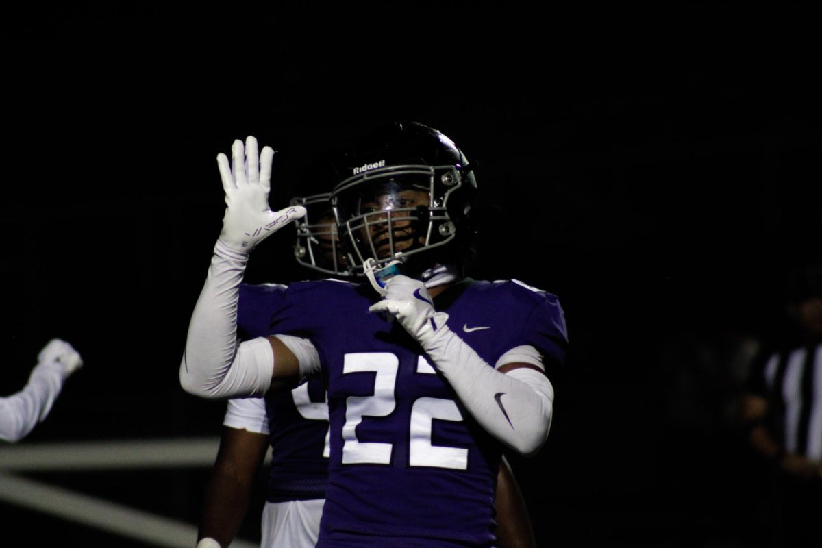 RCHS junior Trejan Jefferson signals to a teammate during their game against Chaparral High School