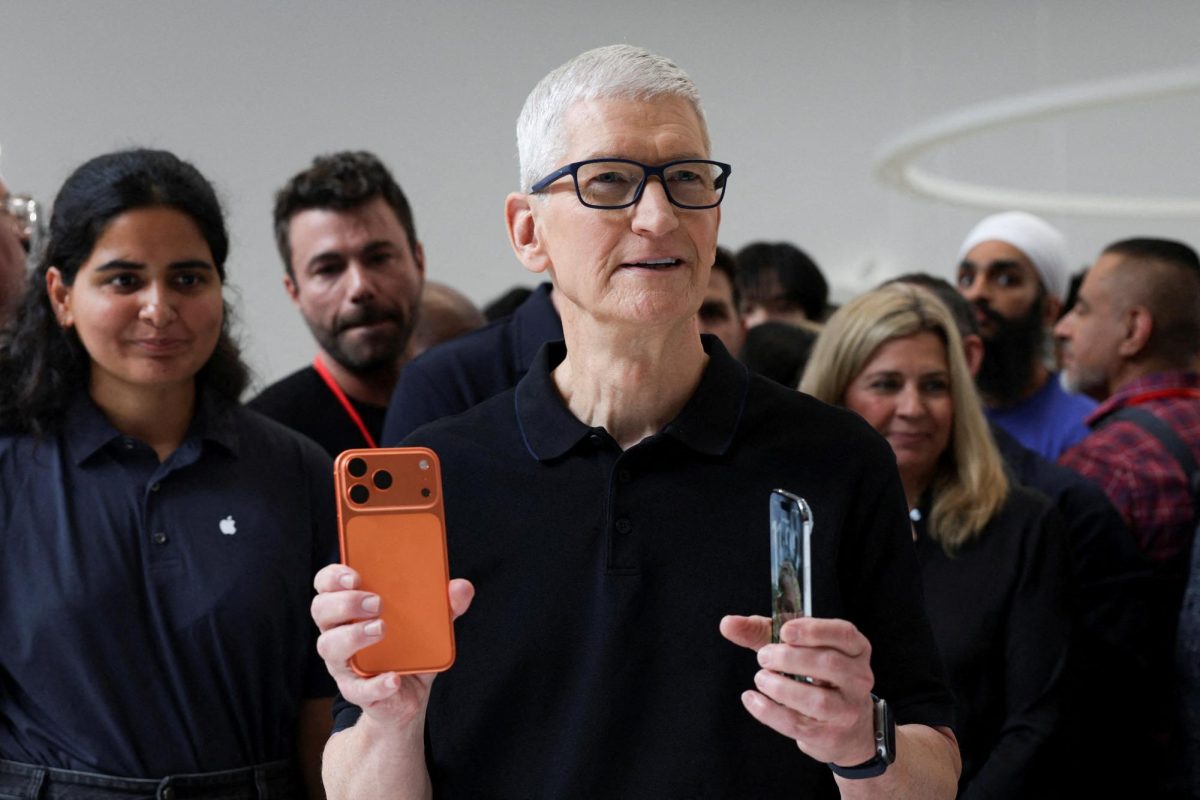 Apple CEO Tim Cook holds an iPhone 17 pro and an iPhone Air, as Apple holds an event at the Steve Jobs Theater on its campus in Cupertino, California, U.S. September 9, 2025. REUTERS/Manuel Orbegozo