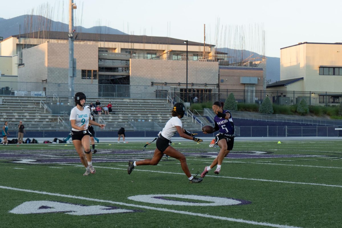 Senior Lizzy Brown evades a flag pull from the Santiago High School defense.