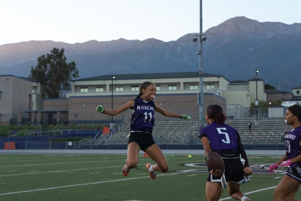 Senior Antoinette Green celebrates with her team after getting an interception against Santiago High School.