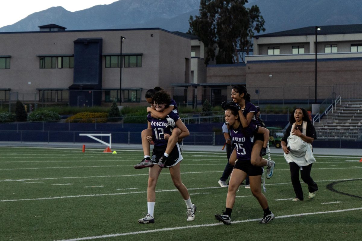 Seniors Avery Siana and ______ carry their teammates off the field after their game against Santiago High School.