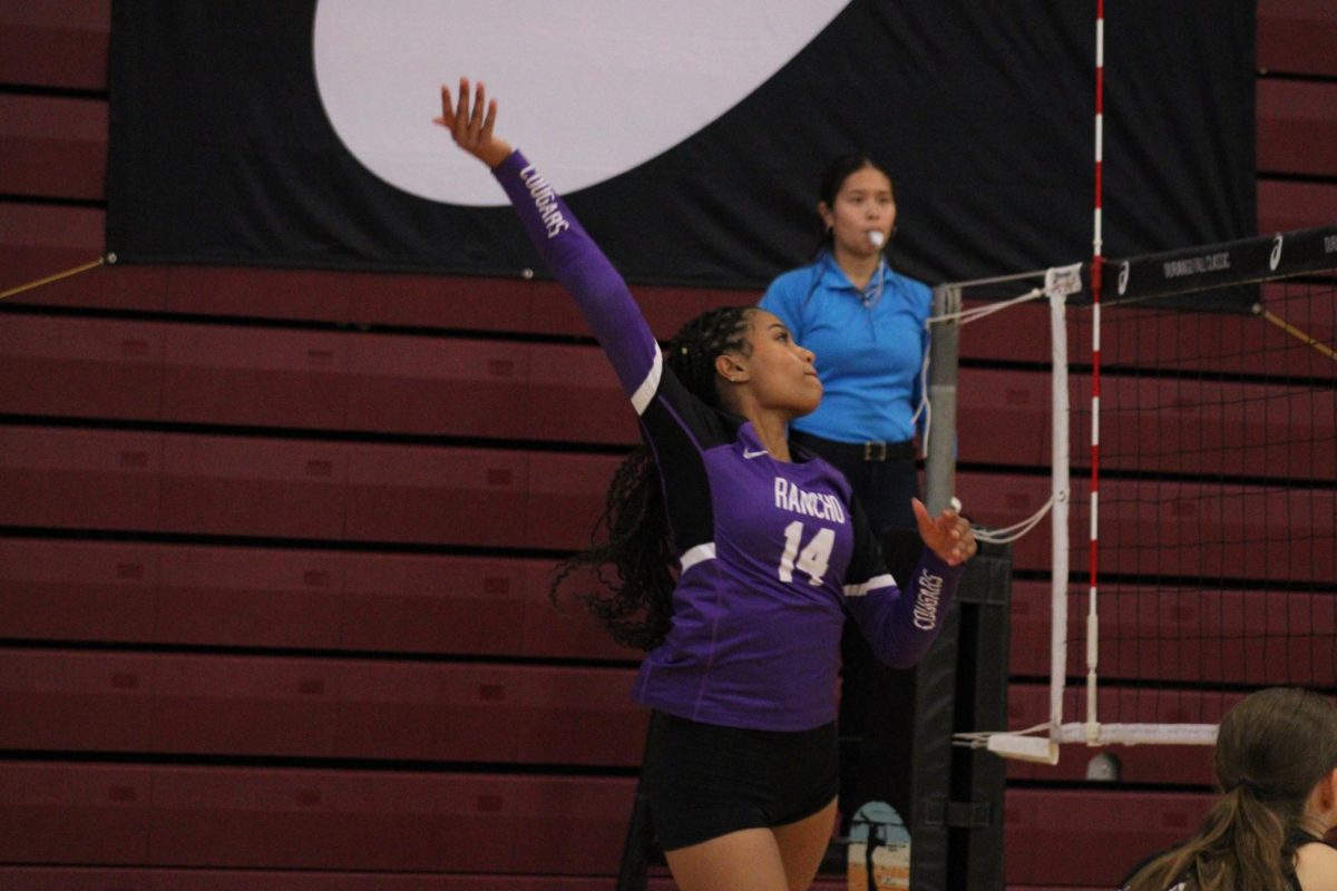 Junior Jayla Jackson rolls the ball over the net in attempt to score a point.