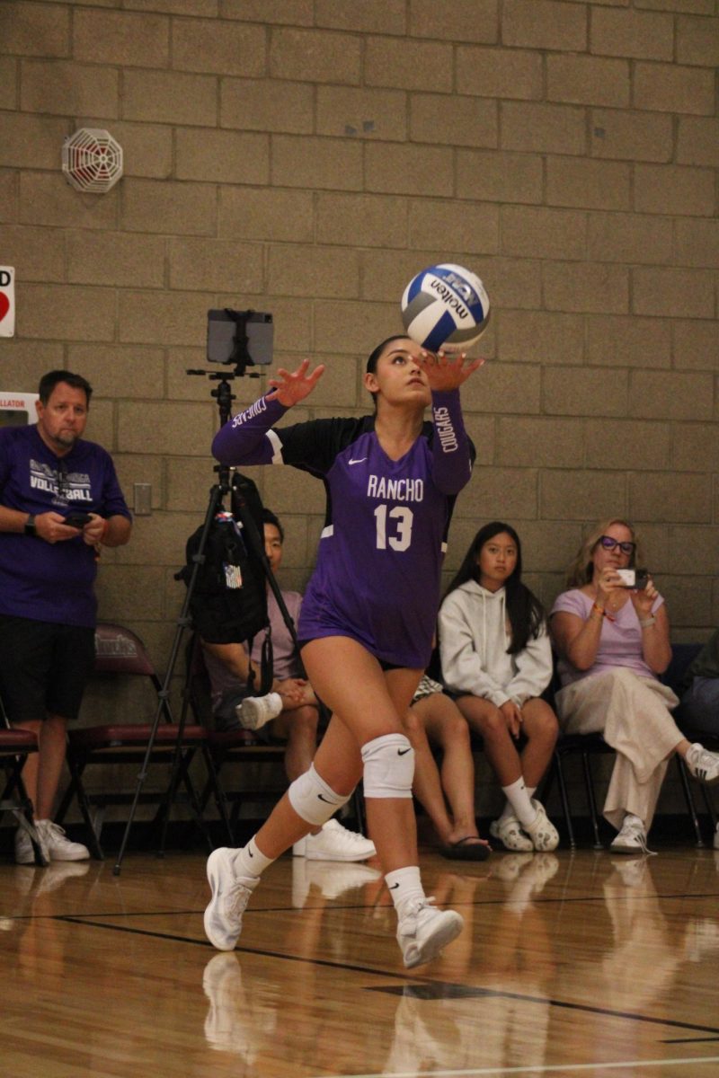 Senior Isabella Duggins serves the ball against Casteel High School