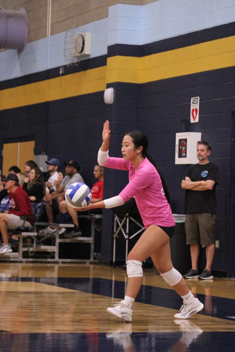 Senior Audrey Chu serves the ball against Desert Oasis High School