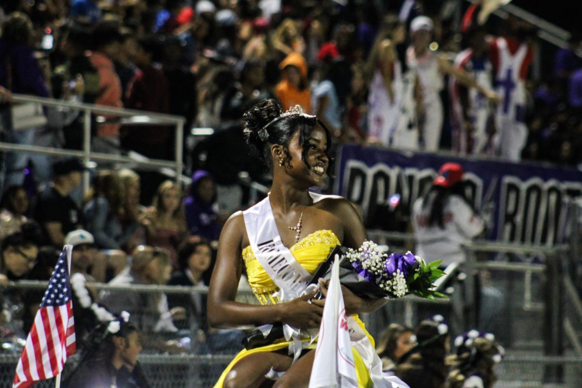 Princess Imani Boiner riding around on Corvette along with the other homecoming princesses at the half time of the football game