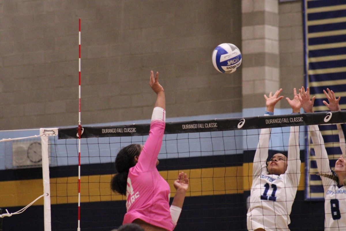 Junior Kamari Johnson hits the ball across the court to avoid the block