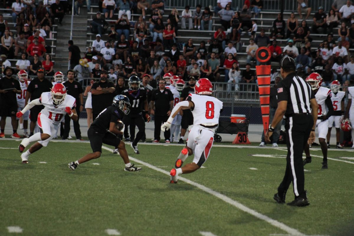 RCHS Senior Tyree Wilson pushes past Oak Hills defenders during Rancho Cucamonga's first home game on Sept. 9.
