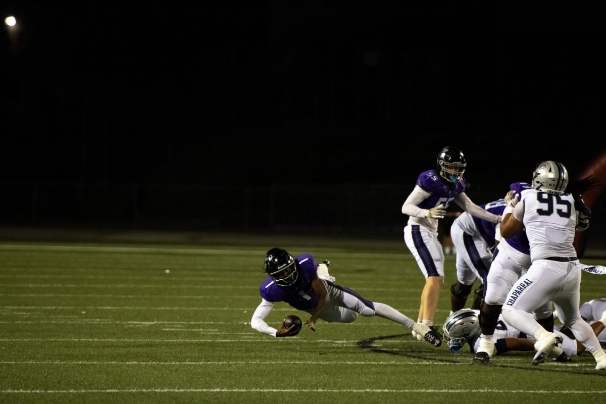 RCHS senior Jacob Chambers falls down after receiving defensive pressure from Chaparral High School.