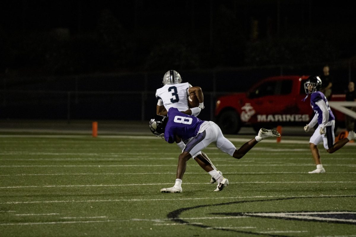 RCHS junior Nate Mensah goes for the tackle against Chaparral High School's quarterback.