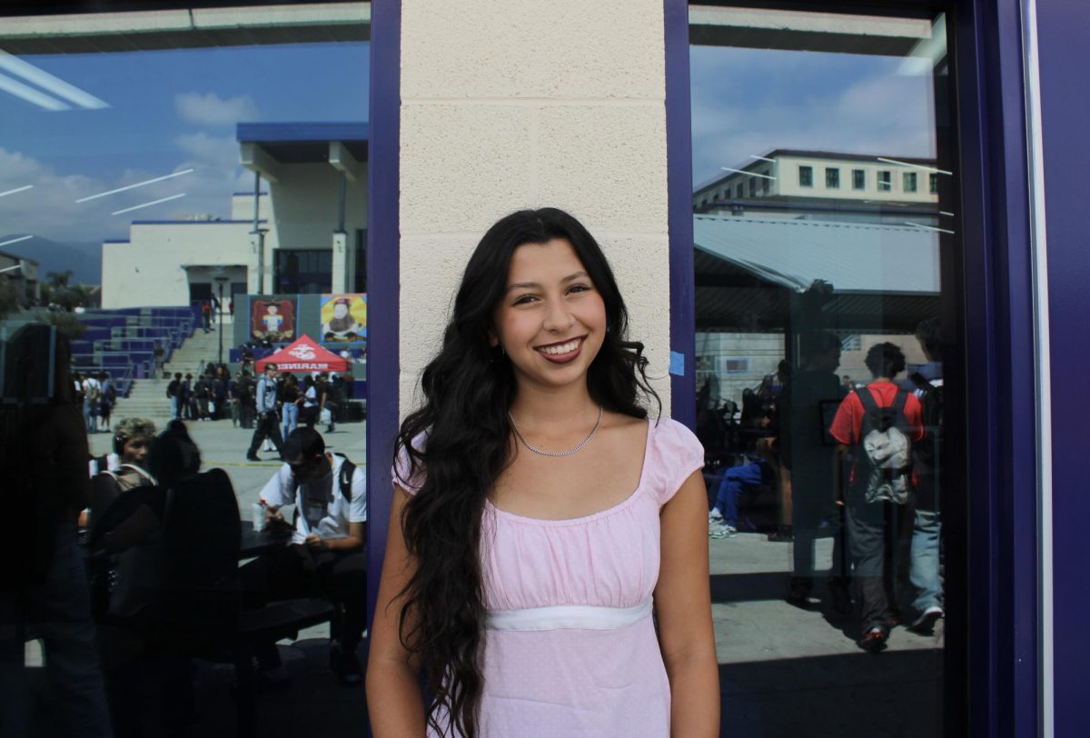 Hoco princess, senior Brooklyn Helper, smiles for a photo. Helper represents the Cross Country team on court. 