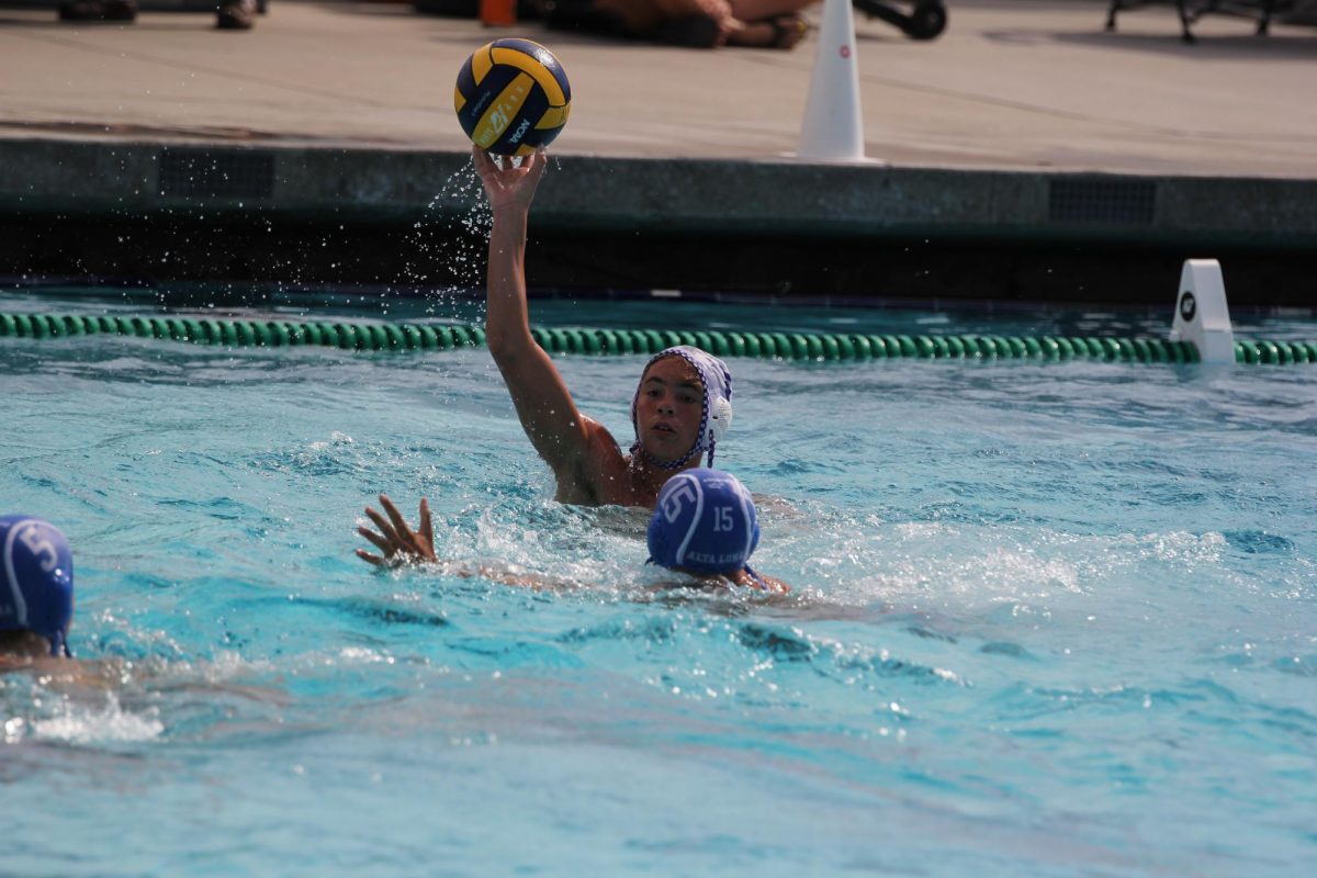 Senior Lukas Ogden passes the ball during a water polo game against Alta Loma High School on Aug. 20. Photo Courtesy: Carissa Gamboa
