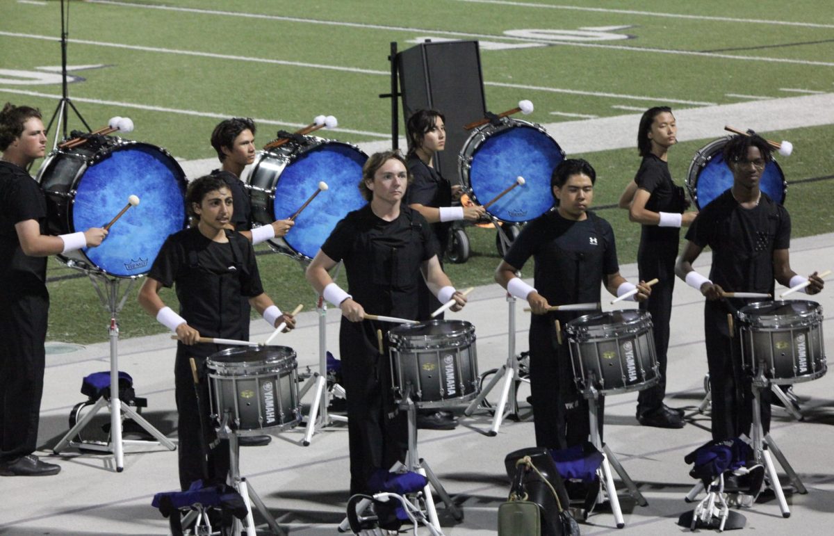 Basses and snares perform for parents and friends during their music demonstration. 