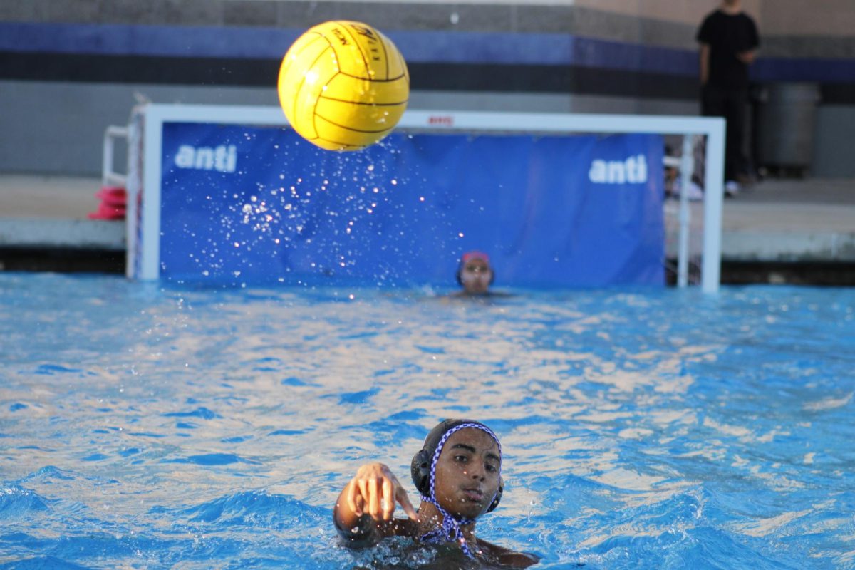 An RCHS water polo player passes the ball during the game against Ramona. 
