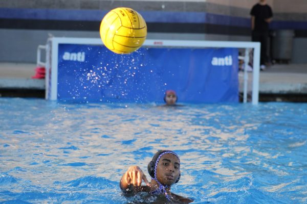 An RCHS water polo player passes the ball during the game against Ramona. 