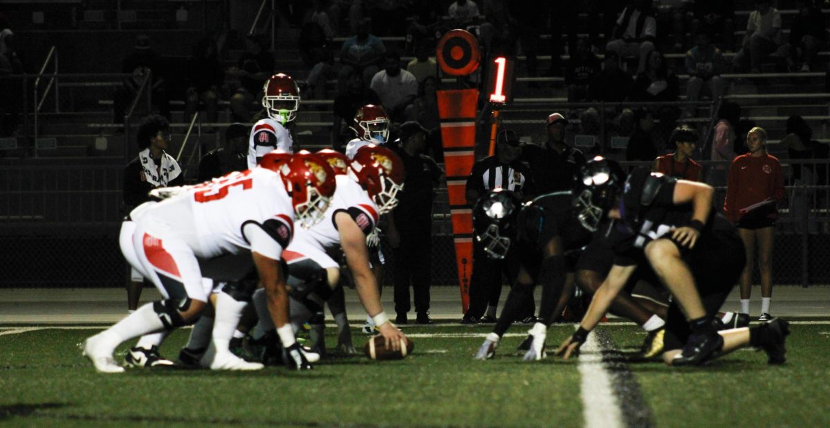 Oak Hills high school prepares to snap the ball against the Rancho Cucamonga high school defensive line