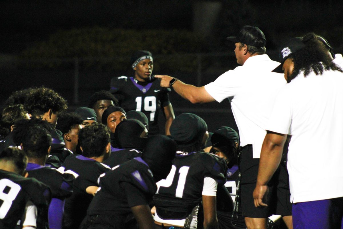 RCHS football Head Coach Alexander Pierce encourages his team after their 14-3 win against Oak Hills at home.