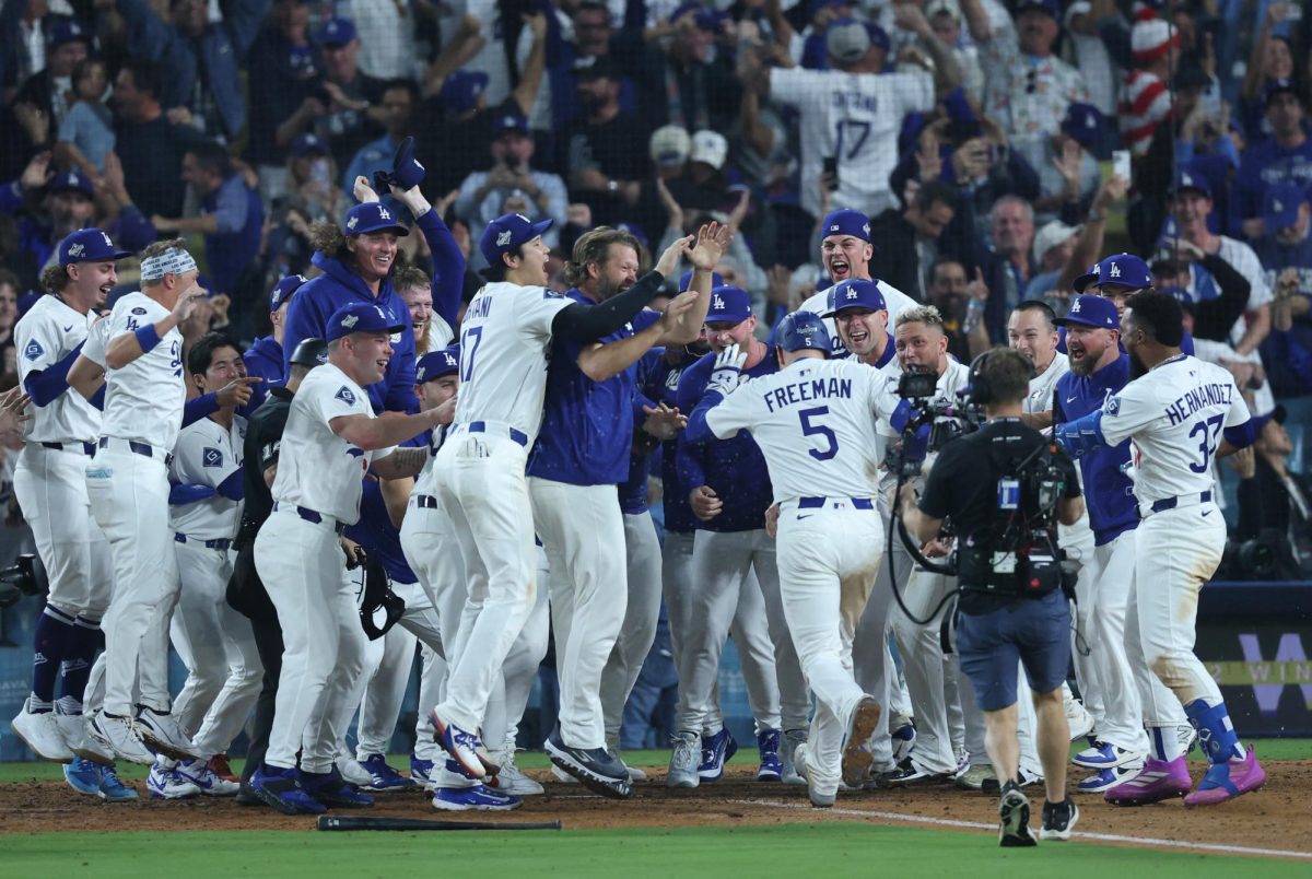 Oct 27, 2025; Los Angeles, California, USA; Los Angeles Dodgers first baseman Freddie Freeman (5) celebrates with teammates after hitting a game-winning home run in the eighteenth inning against the Toronto Blue Jays in game three of the 2025 MLB World Series at Dodger Stadium. Mandatory Credit: Kiyoshi Mio-Imagn Images