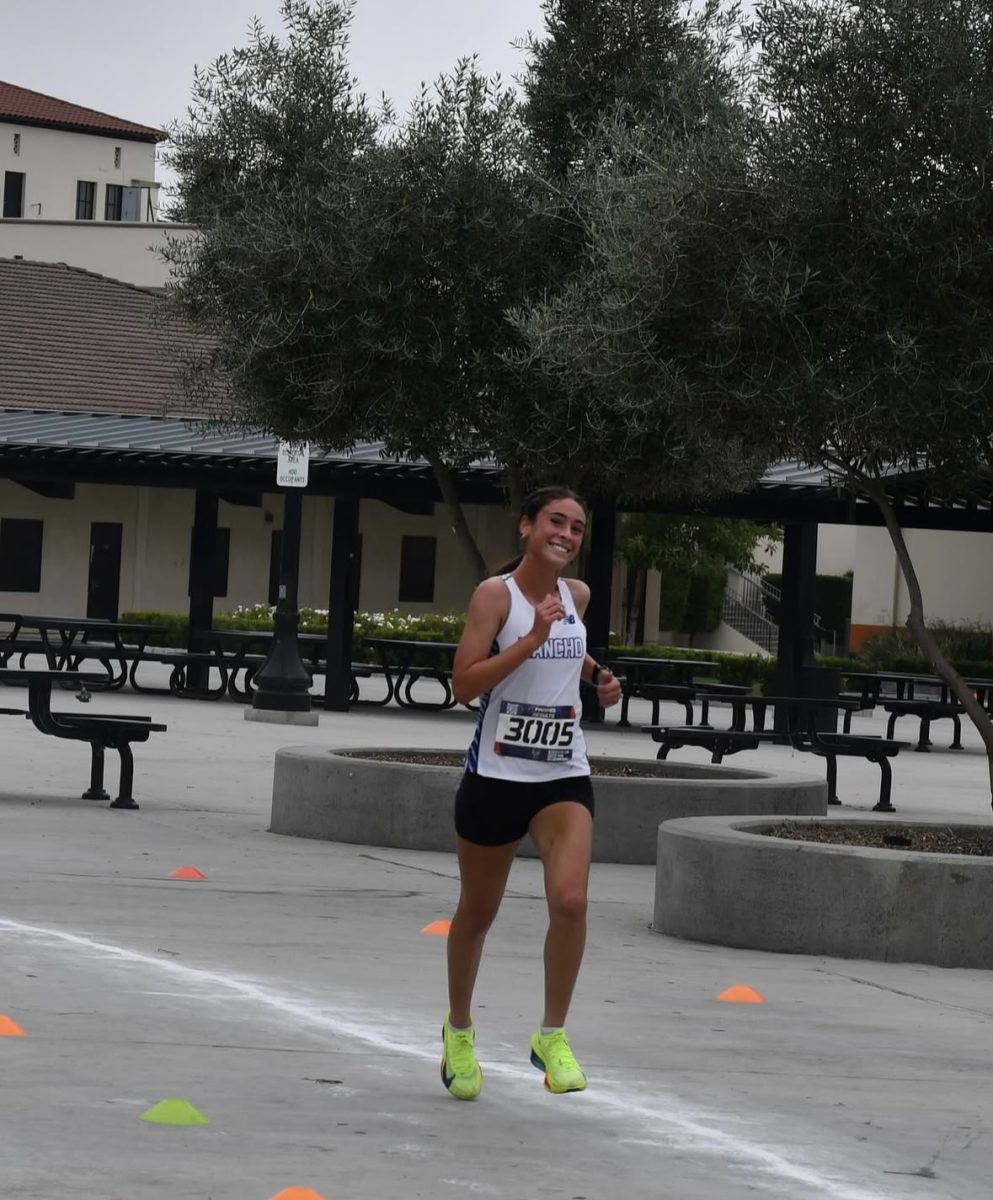 Freshman Emily Bell runs her way to victory with a smile. Photo courtesy: Lisa Murphy
