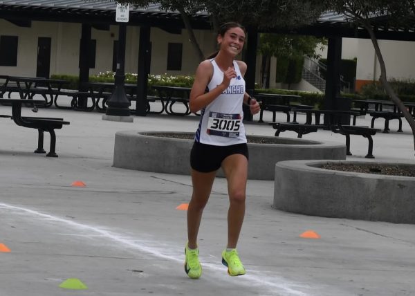 Freshman Emily Bell runs her way to victory with a smile. Photo courtesy: Lisa Murphy
