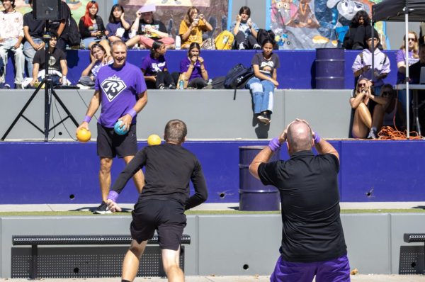 In the quad, as the annual staff dodge ball game proceeds, Mr. Jared Derkson watches in shock as Mr. Chris Van Duin stands on the quad steps.