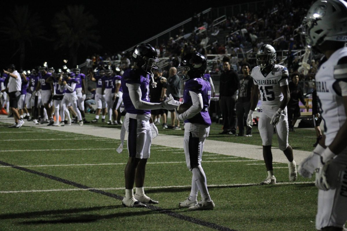Senior RB/WR Tyree Wilson and sophomore WR Semaj Smith do their handshake before the next play.
