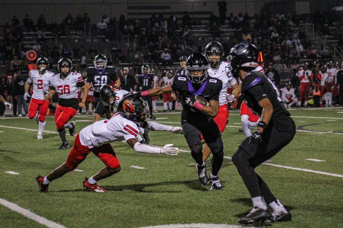 Senior RB James Strong III runs the ball during the Pink Out football game against Etiwanda High School.