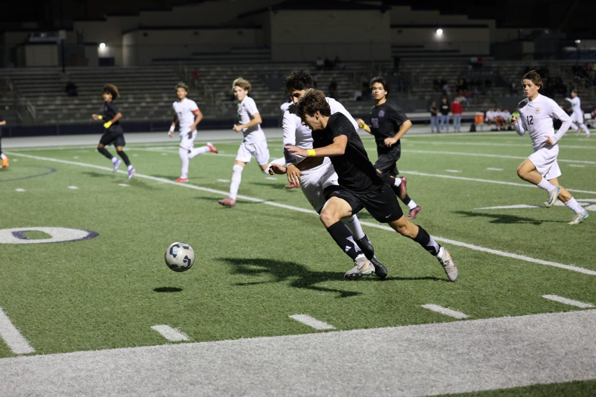 Senior Griffin Fittante dribbles the ball past Etiwanda's defense.
