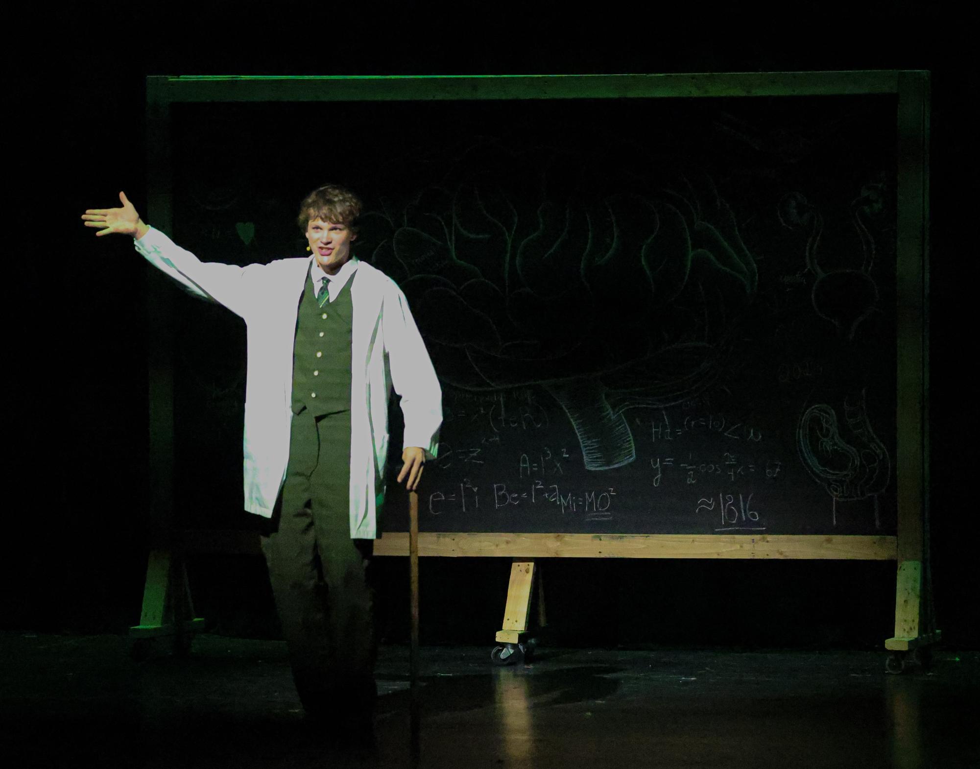 Junior Dawson Hyde faces the audience while holding a cane. 