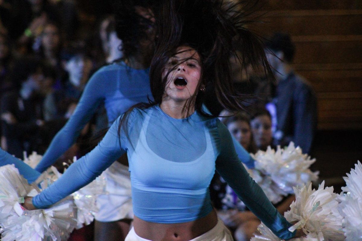 Cash Guerra's hair whips around her during her Ren-Rally performance.